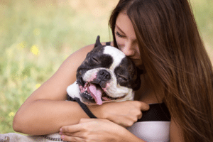 Woman cuddling pet dog